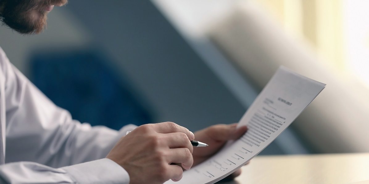 Businessman reading documents; Shutterstock ID 543880450; PO: blog